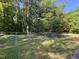 The spacious backyard is enclosed with a chain link fence, offering both security and plenty of room for outdoor activities at 306 Holland Rd, Fuquay Varina, NC 27526