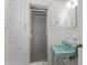 Retro bathroom with a green sink, tiled shower, and storage cabinet at 306 Holland Rd, Fuquay Varina, NC 27526