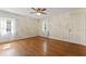 Bedroom with unique geometric wallpaper, hardwood floors, and natural light from multiple windows at 306 Holland Rd, Fuquay Varina, NC 27526