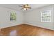 Bright bedroom featuring hardwood floors and two large windows providing ample natural light at 306 Holland Rd, Fuquay Varina, NC 27526