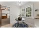 Breakfast nook features a table with a decorative rug, and views of the outdoors through bright windows at 306 Holland Rd, Fuquay Varina, NC 27526