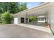 Spacious carport attached to a white brick home with a view of the screened porch at 306 Holland Rd, Fuquay Varina, NC 27526