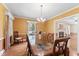 Dining room with wood table, chandelier and a view into the living room at 306 Holland Rd, Fuquay Varina, NC 27526
