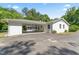 Rear exterior of a charming white brick home with an attached carport and screened porch at 306 Holland Rd, Fuquay Varina, NC 27526