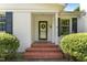 A charming brick entryway leads to the front door with green wreath and sets the stage for a warm welcome at 306 Holland Rd, Fuquay Varina, NC 27526