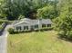 Aerial showcases the home's beautiful landscaping, a driveway, and an idyllic setting at 306 Holland Rd, Fuquay Varina, NC 27526