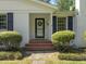 A charming front porch features brick steps, manicured bushes, and a welcoming front door at 306 Holland Rd, Fuquay Varina, NC 27526