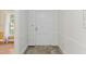 Hallway featuring carpet flooring with a white door and trim and an adjacent room visible at 306 Holland Rd, Fuquay Varina, NC 27526