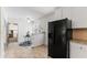 Bright kitchen features a breakfast nook, white cabinets, black refrigerator, and tile flooring at 306 Holland Rd, Fuquay Varina, NC 27526