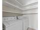 Functional laundry room with shelving and modern washer and dryer units at 306 Holland Rd, Fuquay Varina, NC 27526