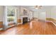 Bright living room featuring hardwood floors, fireplace, large windows and neutral colored walls at 306 Holland Rd, Fuquay Varina, NC 27526