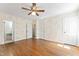 This bedroom features hardwood floors and geometric wallpaper, with an ensuite bathroom at 306 Holland Rd, Fuquay Varina, NC 27526