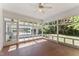 Sunroom featuring tiled flooring, a ceiling fan, and multiple windows overlooking the backyard at 306 Holland Rd, Fuquay Varina, NC 27526