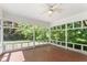 Screened sunroom with tile flooring and multiple windows overlooking the backyard at 306 Holland Rd, Fuquay Varina, NC 27526