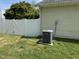 A/C unit in the side yard, next to a white vinyl fence at 309 Westfield Dr, Dunn, NC 28334