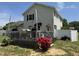 The backyard boasts a charming deck with bright red azaleas and a woodpile in the corner at 309 Westfield Dr, Dunn, NC 28334