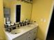 This bathroom features double sinks and vanities with a large mirror and lots of storage space at 309 Westfield Dr, Dunn, NC 28334