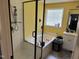 This bathroom features a shower and bath combo with a privacy window near the sink and countertop at 309 Westfield Dr, Dunn, NC 28334