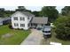 Two-story home with cream siding, black shutters, and a boat parked in the driveway at 309 Westfield Dr, Dunn, NC 28334