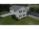 Two-story home with cream siding, black shutters, a nice lawn, and a boat parked in the driveway at 309 Westfield Dr, Dunn, NC 28334