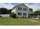 Two-story home with cream siding, black shutters, and a boat parked in the driveway at 309 Westfield Dr, Dunn, NC 28334