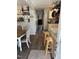 Open kitchen and dining area with hardwood floors, ample shelving and natural light at 309 Westfield Dr, Dunn, NC 28334
