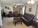 Large living room with leather furniture, a ceiling fan, and natural light at 309 Westfield Dr, Dunn, NC 28334