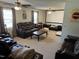 Open concept living room with a ceiling fan, leather furniture, and a projector screen at 309 Westfield Dr, Dunn, NC 28334