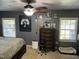 This main bedroom features a ceiling fan, carpet flooring, and Cowboys themed decorations at 309 Westfield Dr, Dunn, NC 28334