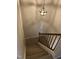 View of carpeted stairway with wooden handrail and decorative pendant lighting fixture at 309 Westfield Dr, Dunn, NC 28334