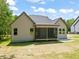 View of the back exterior with a screened-in porch and well maintained lawn at 310 Pilot Ridge Rd, Zebulon, NC 27597