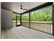 This covered back porch has a ceiling fan and offers expansive views of the surrounding yard at 310 Pilot Ridge Rd, Zebulon, NC 27597