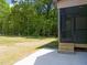 View of a screened-in back porch with wooden stairs and lush green surroundings at 310 Pilot Ridge Rd, Zebulon, NC 27597