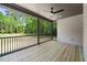 This back porch is covered and features a ceiling fan and wooden floors at 310 Pilot Ridge Rd, Zebulon, NC 27597