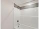 This bathroom features a bathtub with a shower and dark accent tile surround at 310 Pilot Ridge Rd, Zebulon, NC 27597