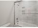 This bathroom features a shower and tub combination with white subway tile and a glass door at 310 Pilot Ridge Rd, Zebulon, NC 27597