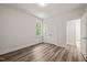 Bright bedroom with durable wood-look floors, a double closet, and a large window overlooking the yard at 310 Pilot Ridge Rd, Zebulon, NC 27597