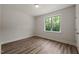 Inviting bedroom with durable wood-look floors and a bright window with backyard views at 310 Pilot Ridge Rd, Zebulon, NC 27597