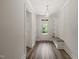 Inviting entryway with a modern light fixture, bench seating, and views of the outdoors at 310 Pilot Ridge Rd, Zebulon, NC 27597