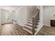 Entryway with open stair access, storage, and natural light, complemented by hardwood floors at 310 Pilot Ridge Rd, Zebulon, NC 27597