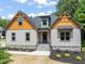 Home exterior with welcoming entrance, showcasing stone accents, trimmed shrubs, and an appealing design at 310 Pilot Ridge Rd, Zebulon, NC 27597