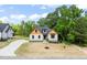Charming exterior view of home with a well-manicured lawn, driveway, and tasteful landscaping at 310 Pilot Ridge Rd, Zebulon, NC 27597