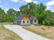 View of home featuring stylish siding, a well-manicured lawn, and a concrete driveway at 310 Pilot Ridge Rd, Zebulon, NC 27597
