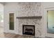 Modern fireplace adds character to the living room with its tile surround and direct patio access at 310 Pilot Ridge Rd, Zebulon, NC 27597