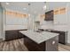 Well-equipped kitchen features a functional island with granite countertop and stainless steel appliances at 310 Pilot Ridge Rd, Zebulon, NC 27597