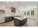 Open kitchen features a large island with granite countertop, modern appliances, and wood plank flooring at 310 Pilot Ridge Rd, Zebulon, NC 27597