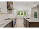Kitchen showcases stainless steel appliances, granite countertops, a functional island, and wood plank flooring at 310 Pilot Ridge Rd, Zebulon, NC 27597