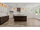 View of the kitchen featuring a central island, stainless steel appliances, and ample cabinet space at 310 Pilot Ridge Rd, Zebulon, NC 27597