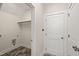 Functional laundry room with tile flooring, utility hookups, and easy access to a hallway with closet space at 310 Pilot Ridge Rd, Zebulon, NC 27597