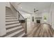 Bright and airy living room featuring stairs, hardwood floors, fireplace, and modern lighting at 310 Pilot Ridge Rd, Zebulon, NC 27597